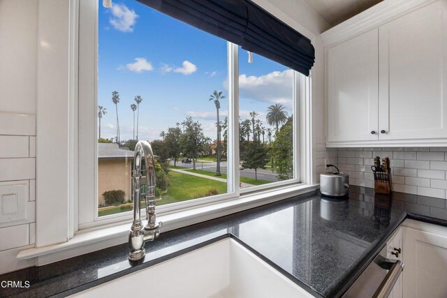 380 S Orange Grove Blvd Unit 6, Pasadena, CA 91105 - kitchen featuring tasteful backsplash, white cabinets, and dark stone counters