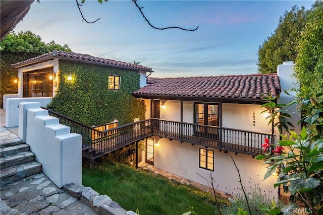 541 Via Del Monte, Palos Verdes Estates, CA 90274 - back of property with a tile roof, stucco siding, a garage, a chimney, and stairway