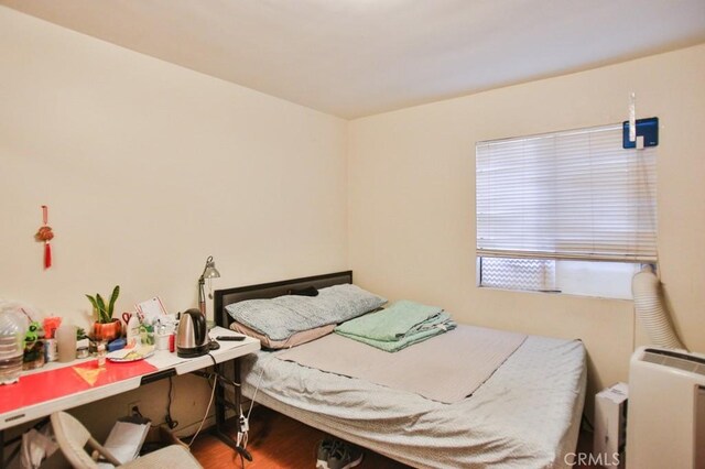 bedroom featuring wood finished floors