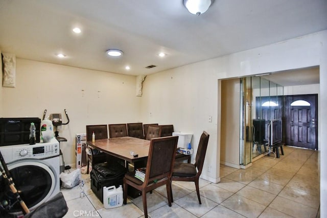 dining space with washer / dryer, recessed lighting, light tile patterned flooring, and water heater