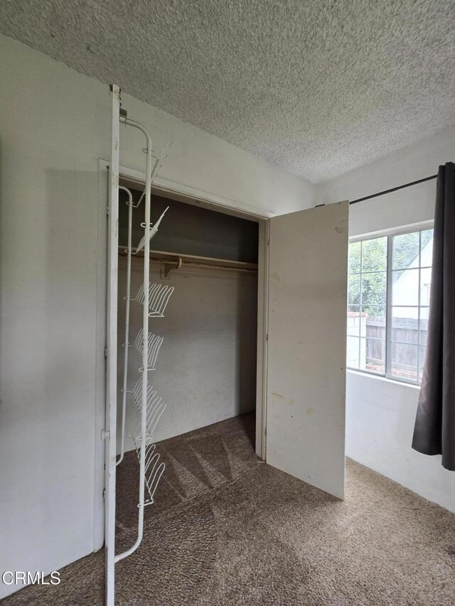 2956 Fashion Ave, Long Beach, CA 90810 - unfurnished bedroom featuring a textured ceiling, carpet floors, and a closet