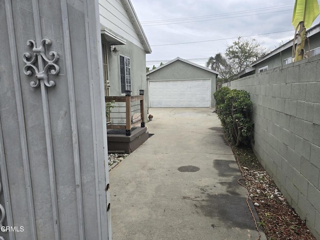2956 Fashion Ave, Long Beach, CA 90810 - view of home's exterior with fence, an outdoor structure, and a garage