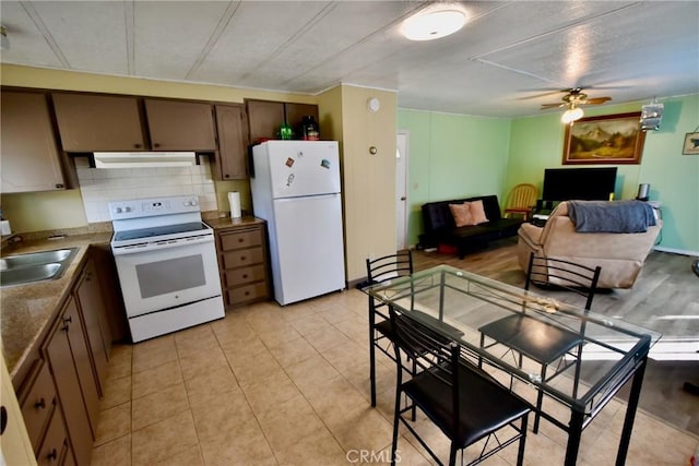 14804 Oregon Rd, Hornbrook, CA 96044 - kitchen featuring white appliances, backsplash, a sink, ceiling fan, and ventilation hood