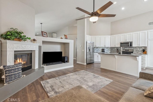40049 Corte Fortuna, Murrieta, CA 92562 - living room with ceiling fan, recessed lighting, dark wood-style flooring, a high end fireplace, and high vaulted ceiling
