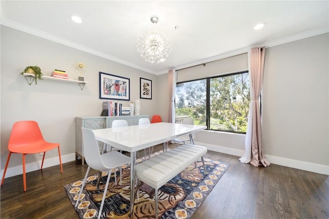 dining area featuring ornamental molding, baseboards, and wood finished floors