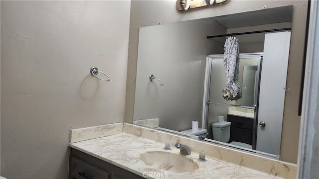 bathroom with toilet and vanity