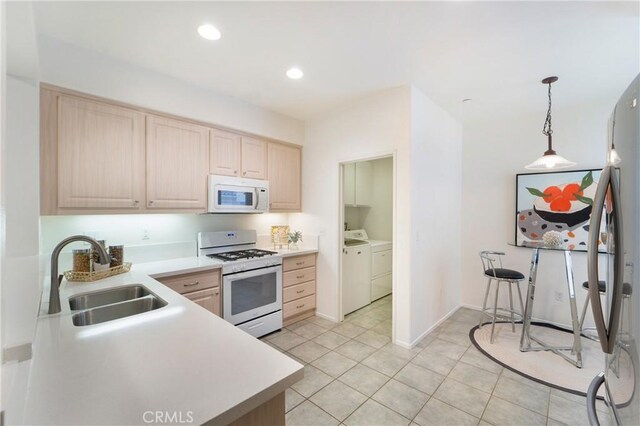 1510 Timberwood, Irvine, CA 92620 - kitchen with white appliances, a sink, light brown cabinetry, washer and dryer, and light countertops