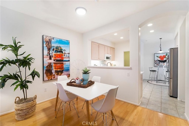 1510 Timberwood, Irvine, CA 92620 - dining area with arched walkways, light wood-style flooring, recessed lighting, and baseboards