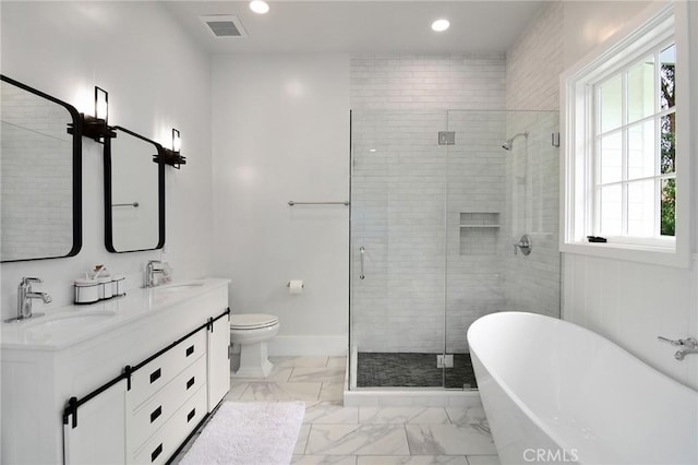 full bathroom with marble finish floor, visible vents, a sink, and a shower stall
