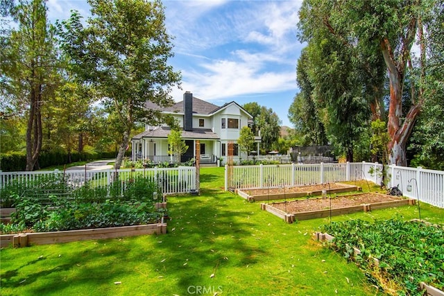 view of yard featuring fence and a garden