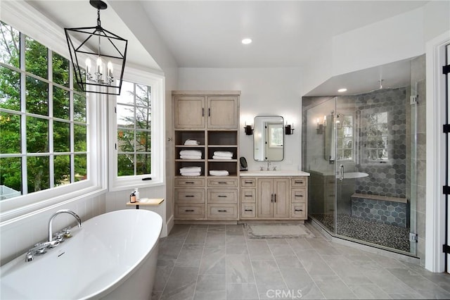 bathroom featuring a stall shower, vanity, a soaking tub, recessed lighting, and an inviting chandelier