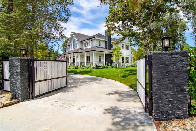 view of gate with a lawn