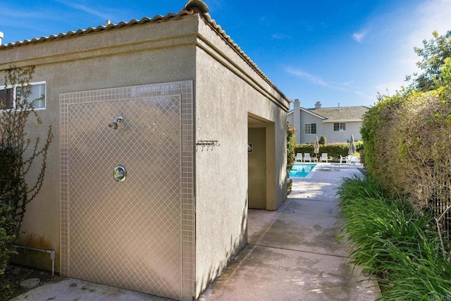 view of home's exterior featuring an outdoor pool and stucco siding