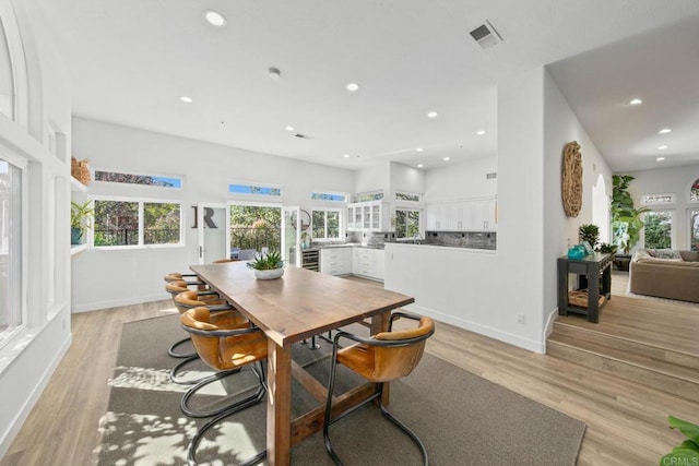 dining room featuring recessed lighting, visible vents, light wood-type flooring, and a healthy amount of sunlight