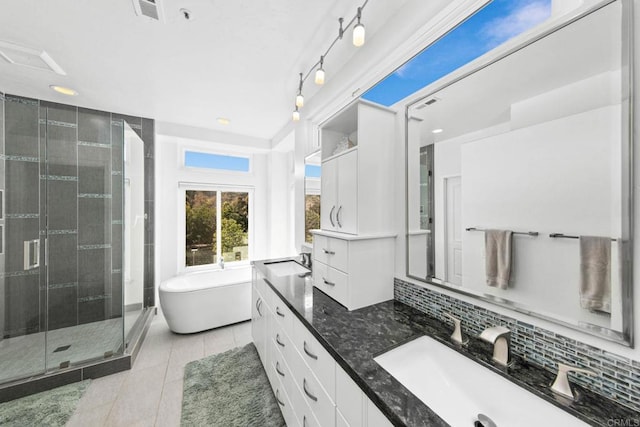 bathroom with tasteful backsplash, a freestanding tub, visible vents, a stall shower, and tile patterned floors
