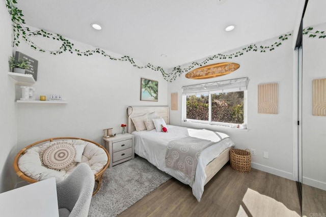 bedroom with baseboards, recessed lighting, and wood finished floors