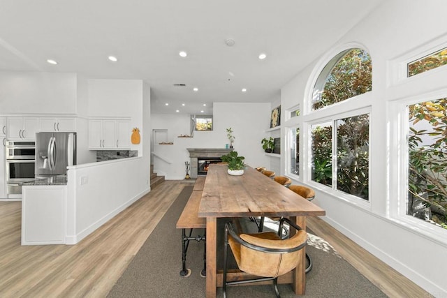dining space with recessed lighting, visible vents, and light wood-type flooring