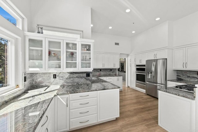 1164 Quail Gardens Ct, Encinitas, CA 92024 - kitchen featuring stainless steel appliances, white cabinets, dark stone countertops, decorative backsplash, and recessed lighting