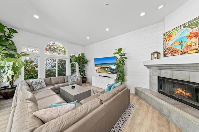 1164 Quail Gardens Ct, Encinitas, CA 92024 - living area with a tile fireplace, wood finished floors, recessed lighting, and wooden walls