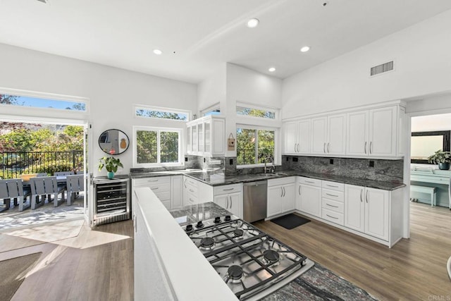 1164 Quail Gardens Ct, Encinitas, CA 92024 - kitchen with wine cooler, appliances with stainless steel finishes, dark wood finished floors, a towering ceiling, and recessed lighting