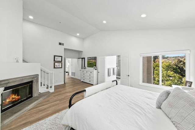1164 Quail Gardens Ct, Encinitas, CA 92024 - bedroom featuring wood finished floors, high vaulted ceiling, recessed lighting, and a glass covered fireplace
