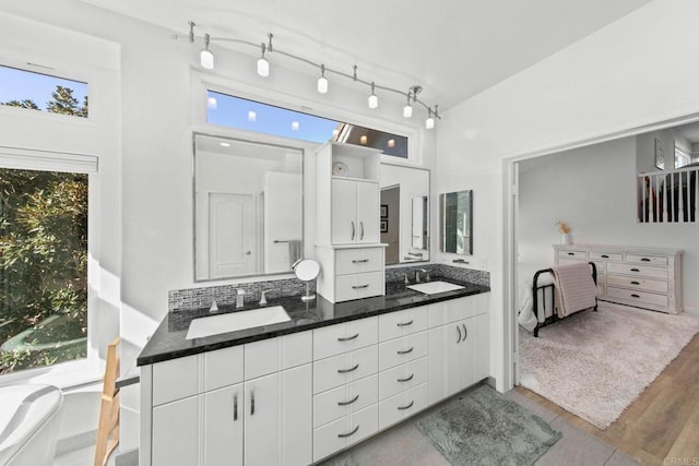 1164 Quail Gardens Ct, Encinitas, CA 92024 - full bath with double vanity, wood finished floors, a freestanding tub, and decorative backsplash