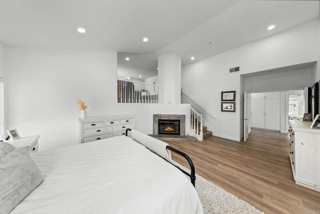 1164 Quail Gardens Ct, Encinitas, CA 92024 - bedroom featuring wood finished floors, recessed lighting, a glass covered fireplace, and baseboards