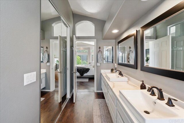 4981 Marin Dr, Oceanside, CA 92056 - bathroom featuring a sink, double vanity, ensuite bath, and wood finished floors