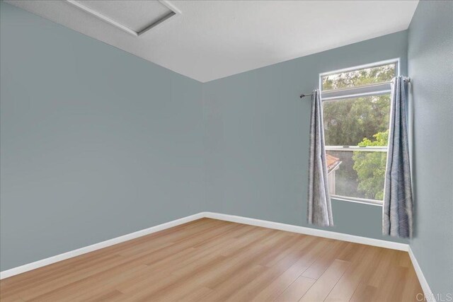 4981 Marin Dr, Oceanside, CA 92056 - spare room with baseboards, wood finished floors, and attic access
