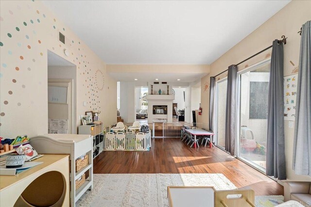 4981 Marin Dr, Oceanside, CA 92056 - living room featuring plenty of natural light, a glass covered fireplace, wood finished floors, and visible vents