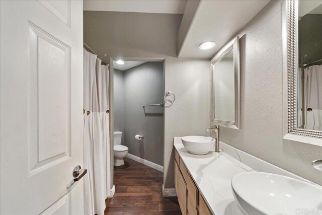 4981 Marin Dr, Oceanside, CA 92056 - bathroom featuring toilet, baseboards, a sink, and wood finished floors