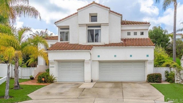 4981 Marin Dr, Oceanside, CA 92056 - mediterranean / spanish house with fence, driveway, a tile roof, and stucco siding