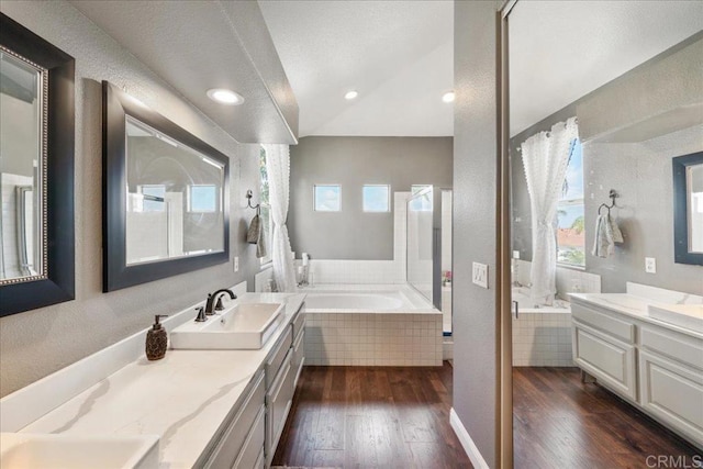 4981 Marin Dr, Oceanside, CA 92056 - bathroom with a bath, vanity, wood-type flooring, recessed lighting, and lofted ceiling