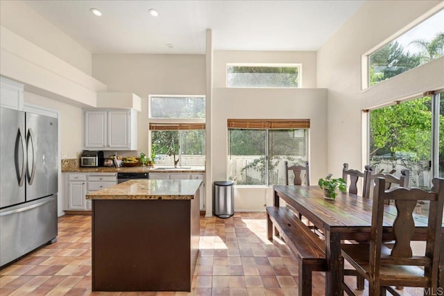 4981 Marin Dr, Oceanside, CA 92056 - kitchen featuring freestanding refrigerator, a high ceiling, dishwasher, recessed lighting, and a kitchen island