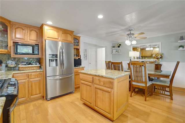 kitchen featuring ornamental molding, stainless steel fridge with ice dispenser, black microwave, and range