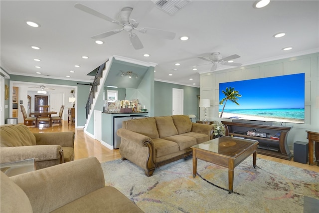 living area featuring visible vents, ceiling fan, and a dry bar
