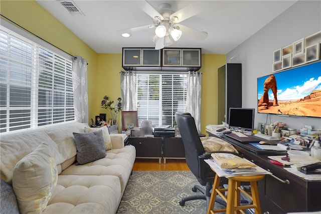 office with wood finished floors, ceiling fan, and visible vents