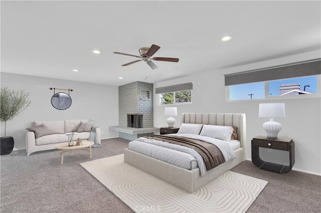 bedroom with ceiling fan, carpet flooring, a fireplace, and recessed lighting