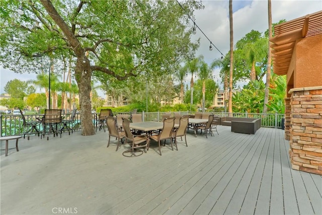 deck with outdoor dining area