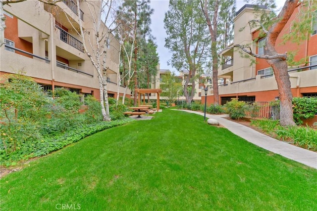 view of property's community with a yard