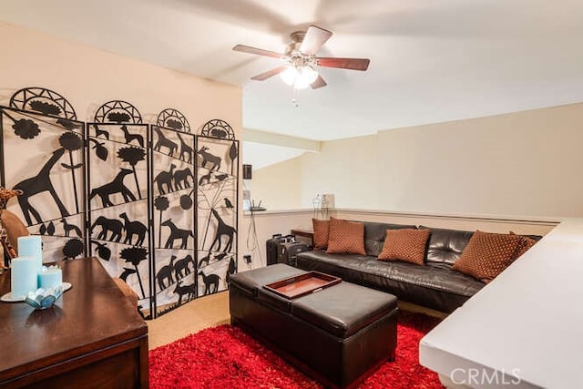 carpeted living room with a ceiling fan