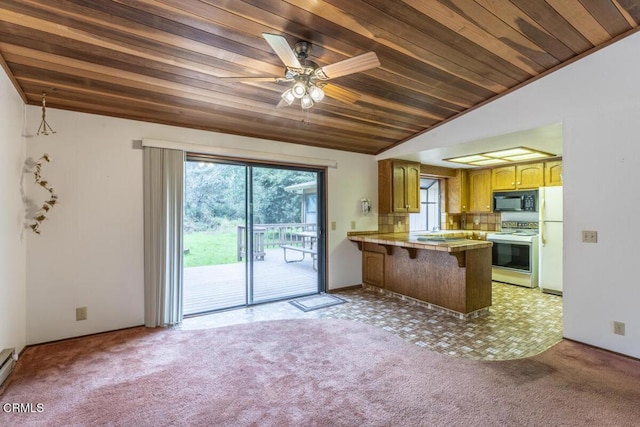 kitchen with lofted ceiling, light colored carpet, white appliances, wooden ceiling, and a peninsula