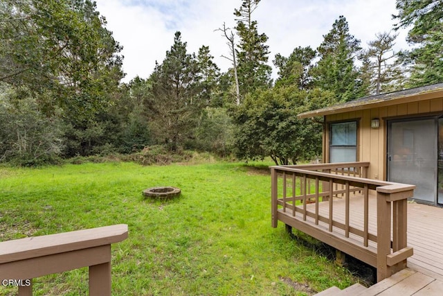 view of yard featuring a fire pit and a deck