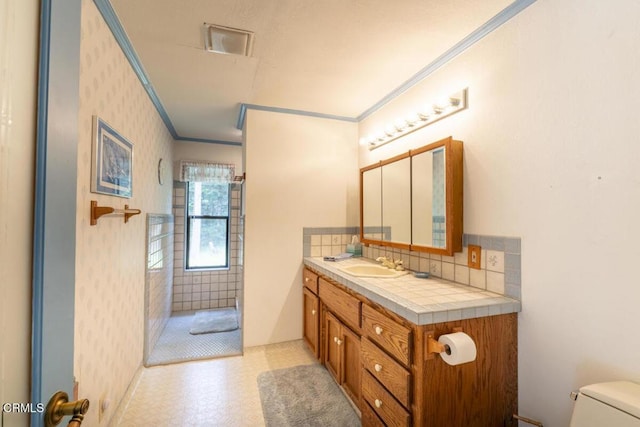 bathroom with crown molding, walk in shower, toilet, tile patterned floors, and vanity