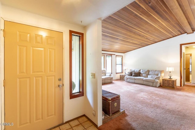 foyer featuring light carpet, lofted ceiling, and wooden ceiling