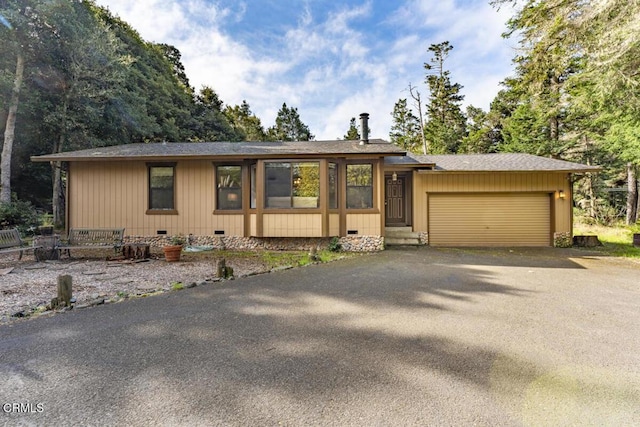 view of front of house featuring driveway, crawl space, a garage, and a shingled roof