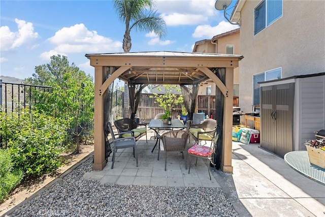 view of patio / terrace featuring outdoor dining space, a gazebo, and fence