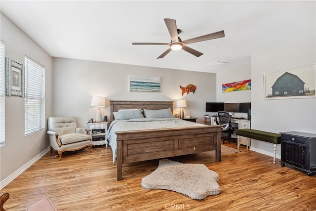 bedroom with light wood-style flooring, ceiling fan, and baseboards