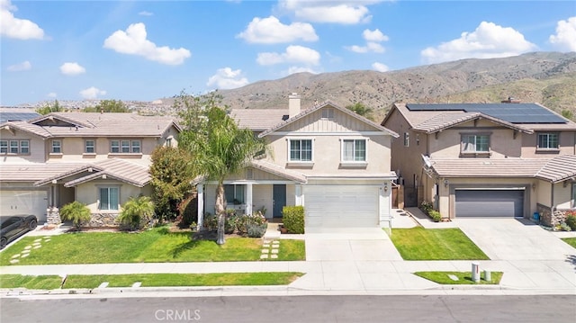 view of front of house with a front yard, an attached garage, driveway, and stucco siding