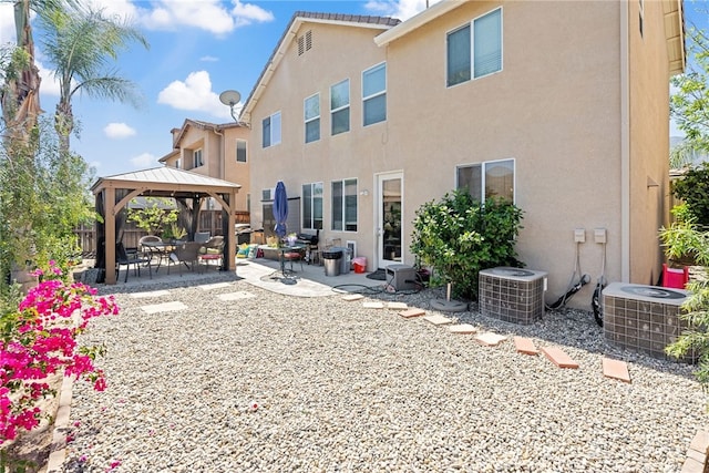 rear view of house with a gazebo, a patio, stucco siding, and cooling unit